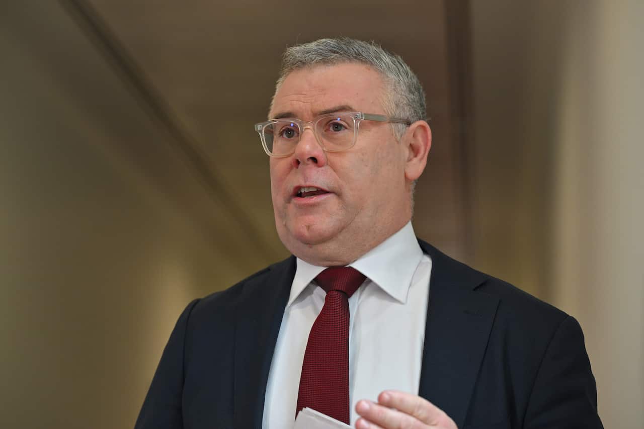 A man in a suit speaking