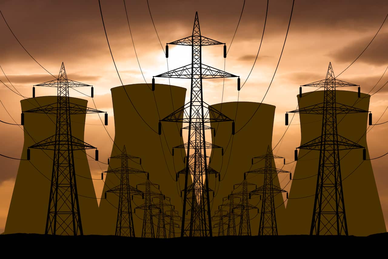 A nuclear power plant at dusk. 