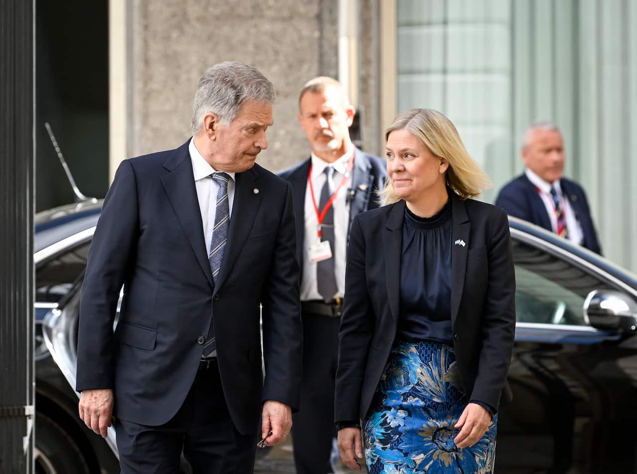 Finland's President Sauli Niinisto (L) and Sweden's Prime Minister Magdalena Andersson walking and talking.