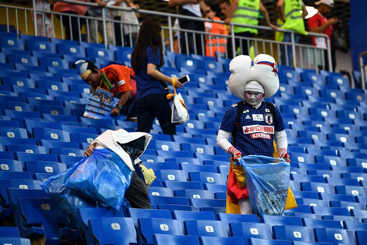 Person cleaning stadium.