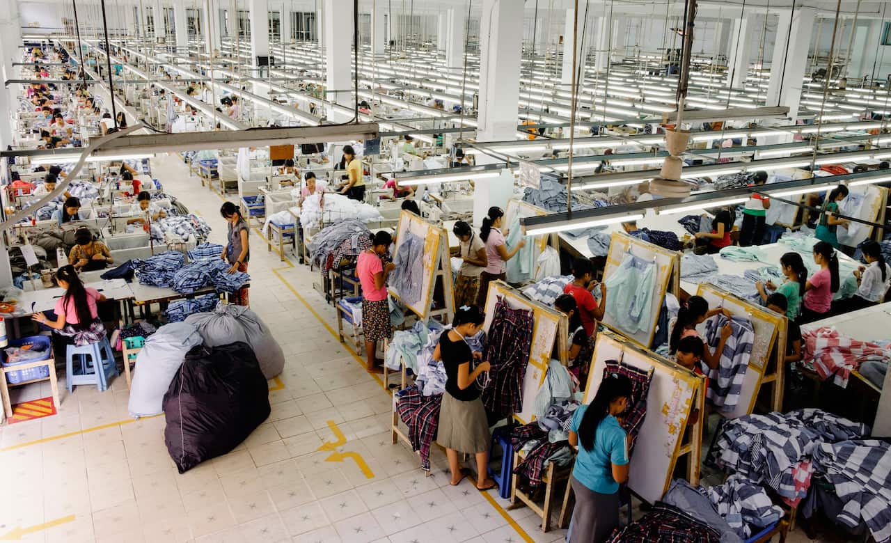 A high angle view of workers in a large garment factory.