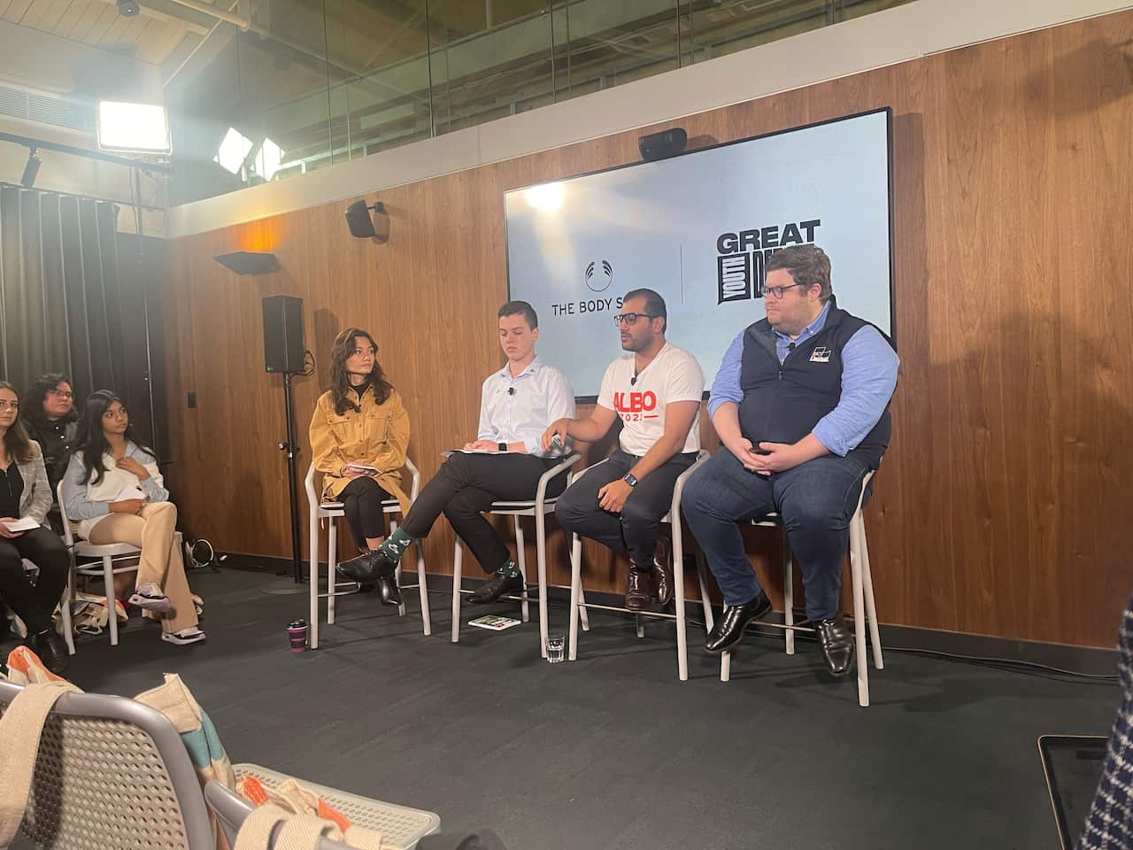Three men and a woman sit side by side. 