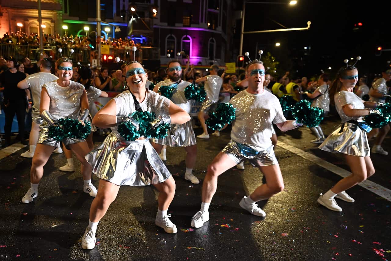 Dancers in cheerleader outfits participating in Mardi Gras