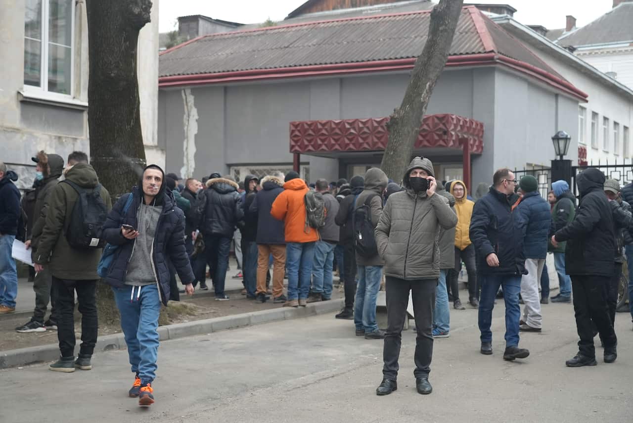 Dozens of people standing in line at the conscript office in Lviv