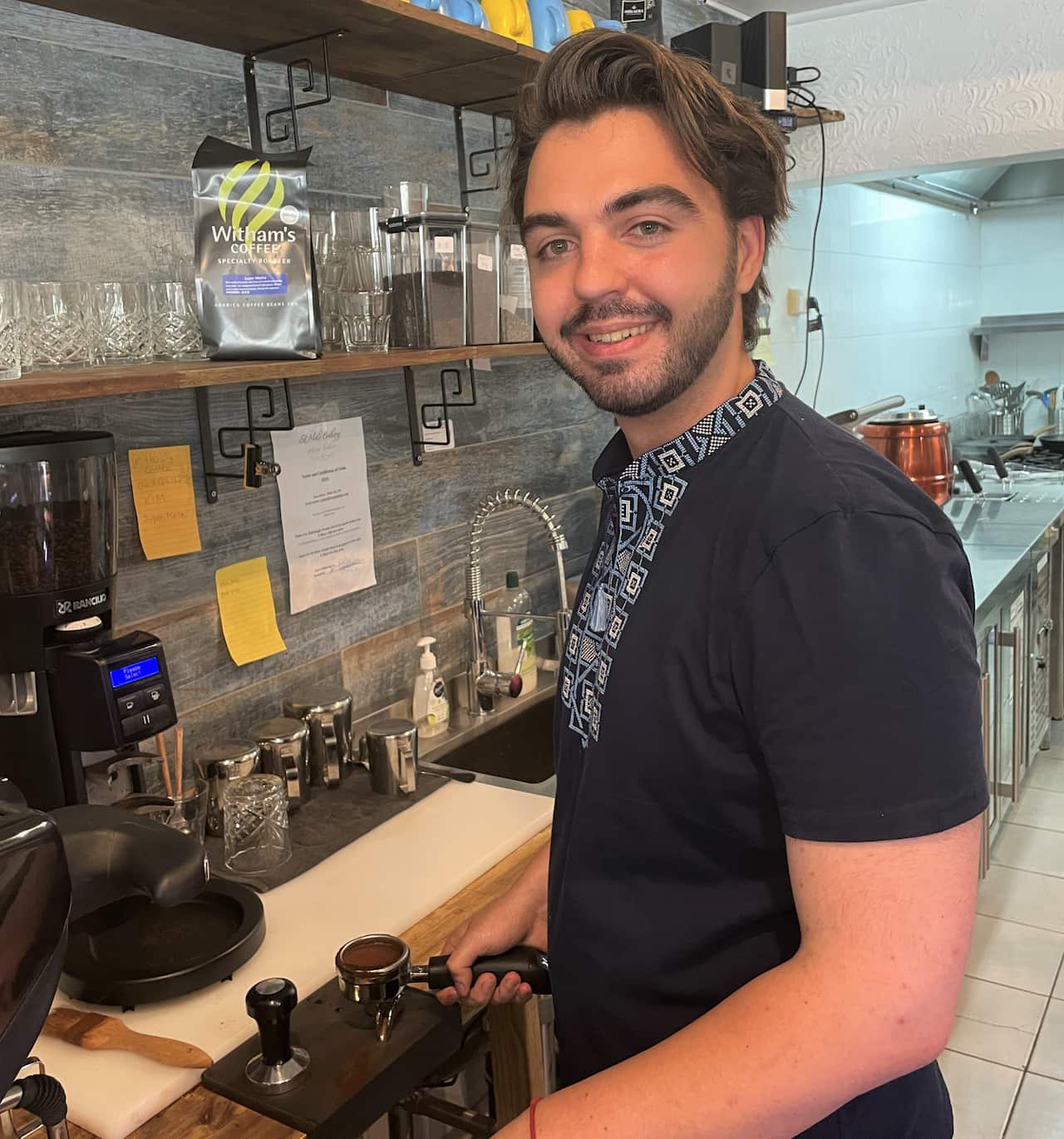 A man making a coffee in a cafe