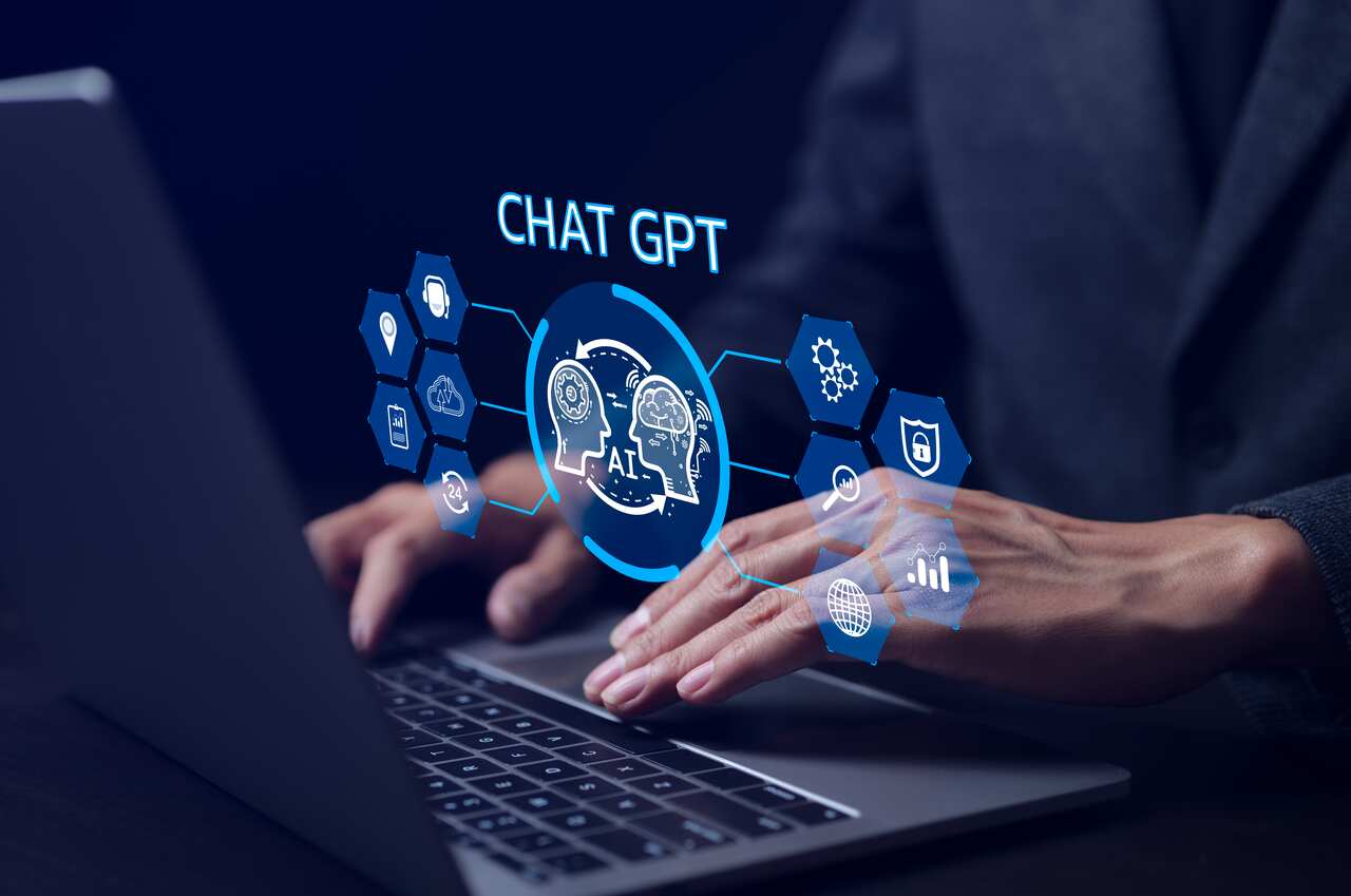 ChatGPT Chat with AI or Artificial Intelligence technology. businessman using a laptop computer chatting with an intelligent artificial intelligence. Developed by OpenAI. Futuristic technology.