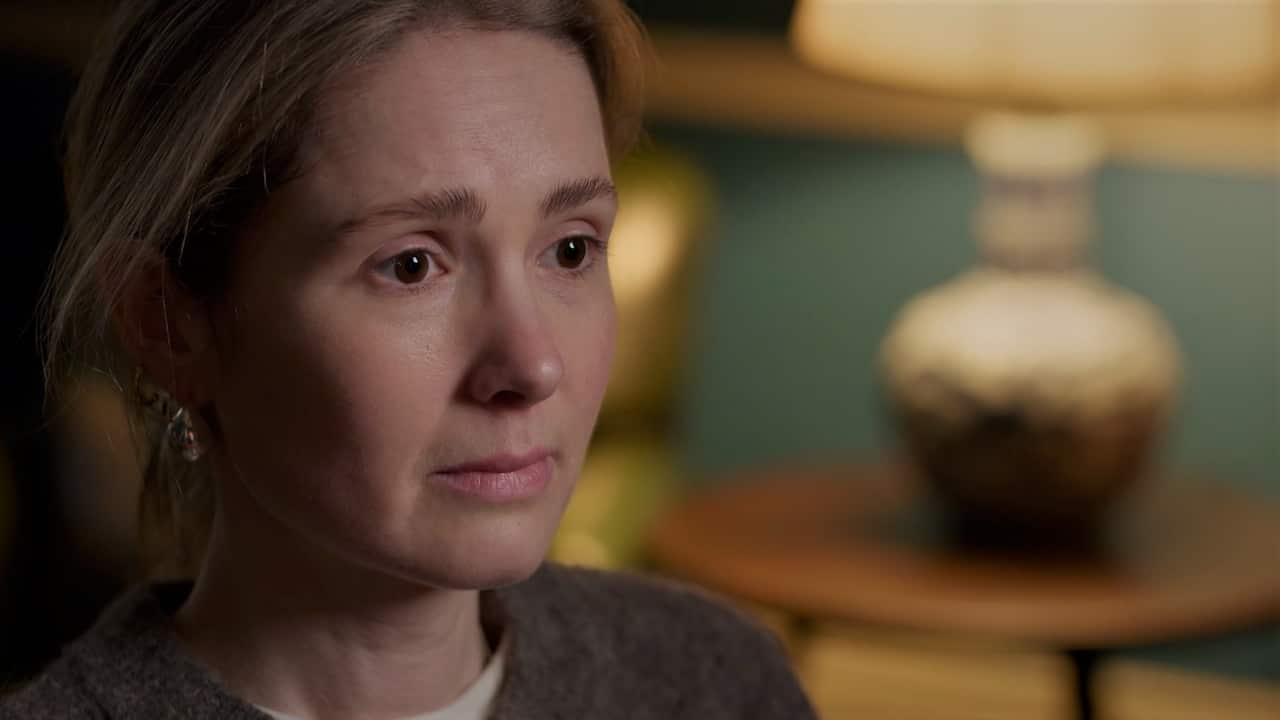 A close-up of a woman's face with dark blonde hair