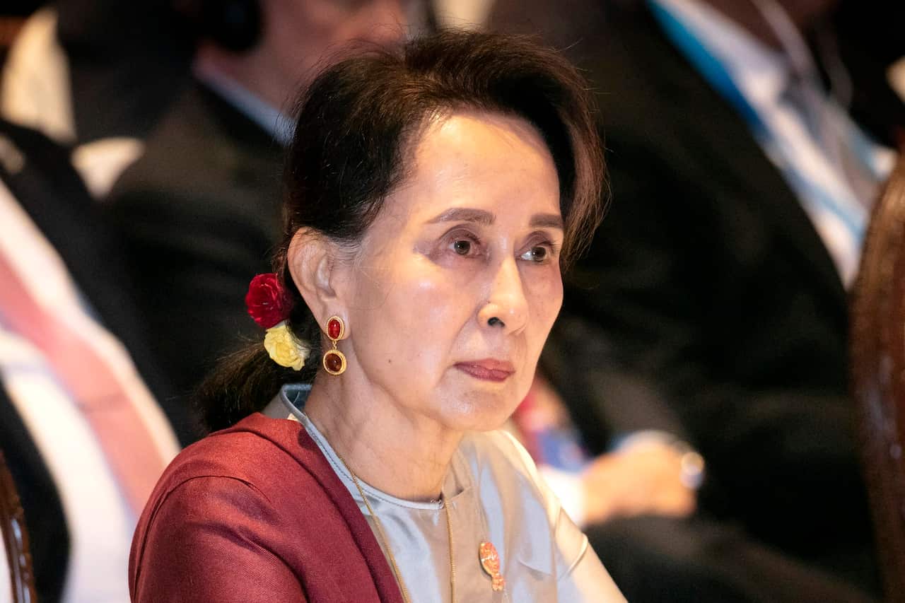  Myanmar's former leader Aung San Suu Kyi with a serious facial expression, looking away. 