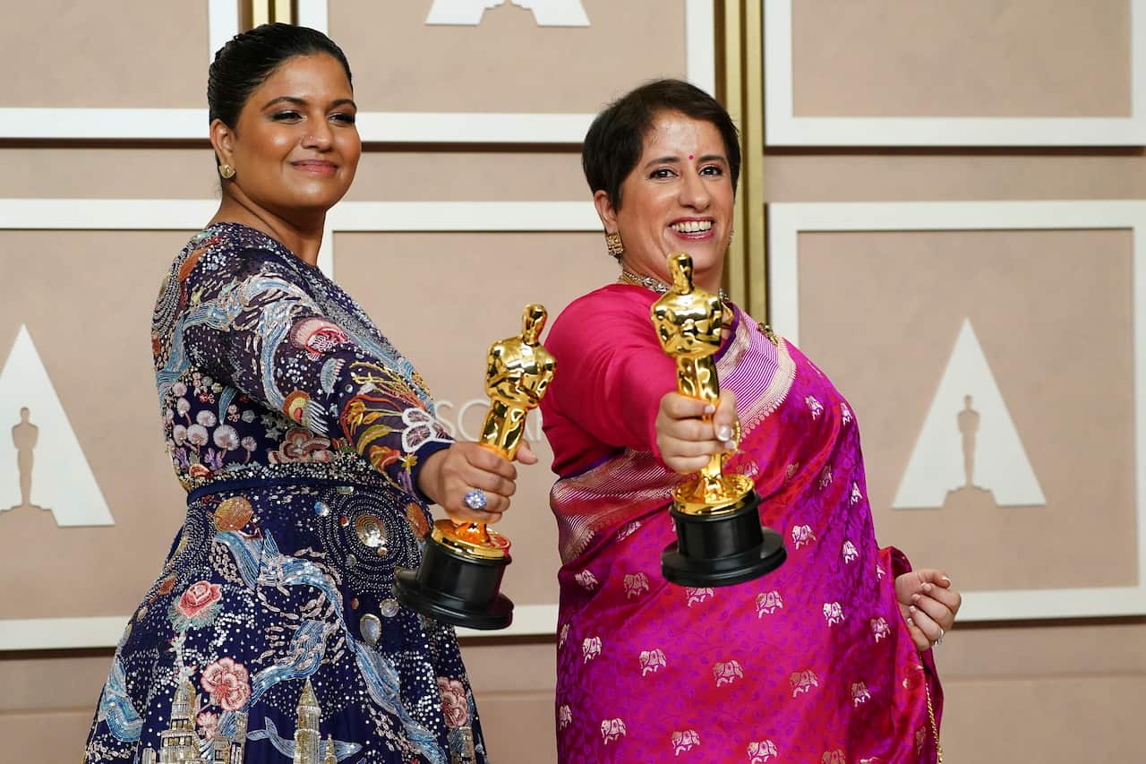 Kartiki Gonsalves (left) and Guneet Monga hold their Oscars for best documentary short film, The Elephant Whisperer.