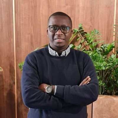 Noël Zihabamwe standing with arms crossed