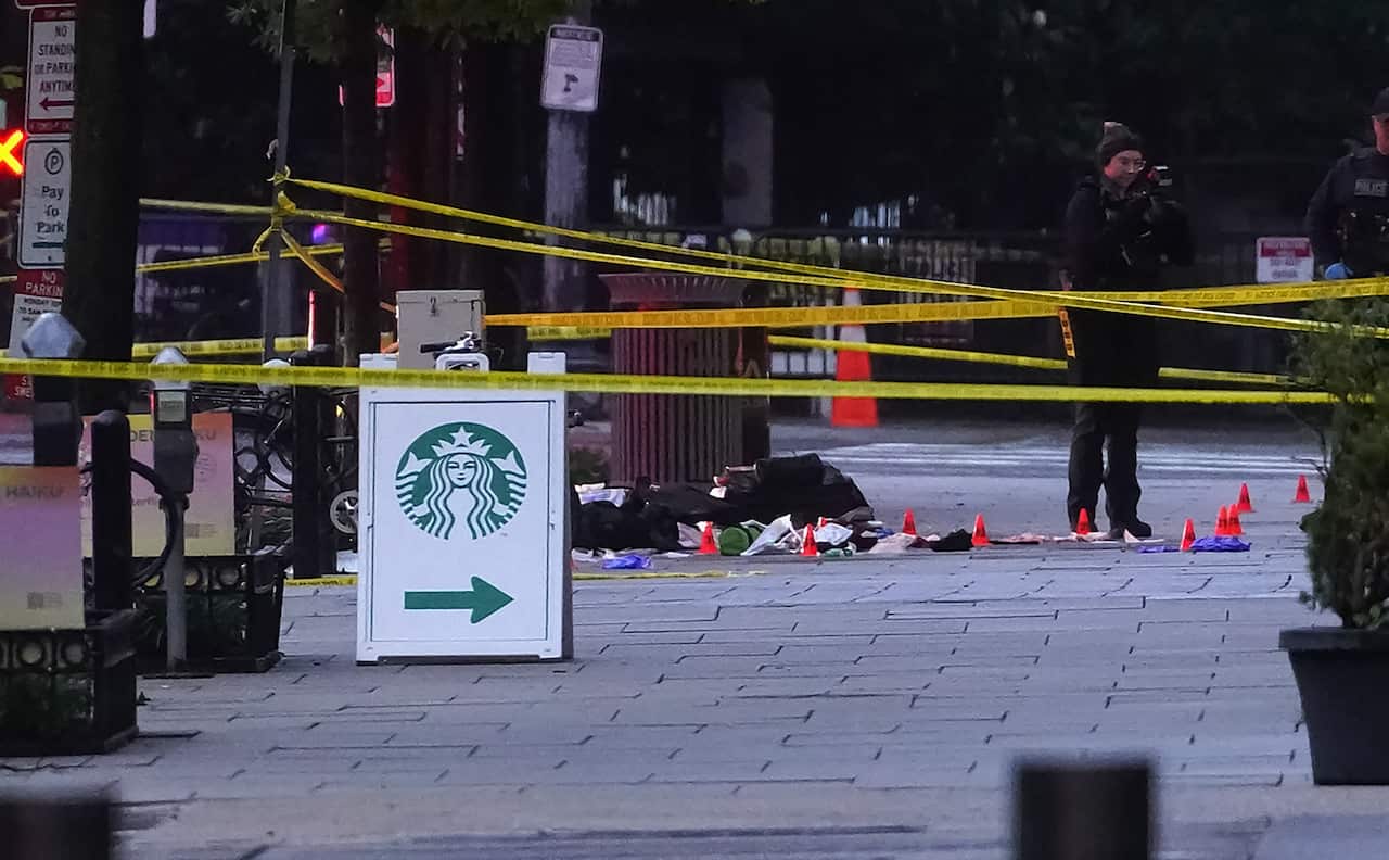 A crime scene with a Starbucks sign in front.