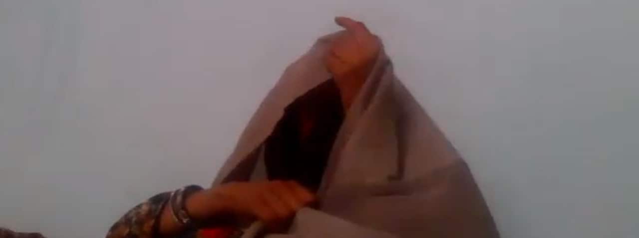 Screenshot of a Zoom interview with a veiled woman. 