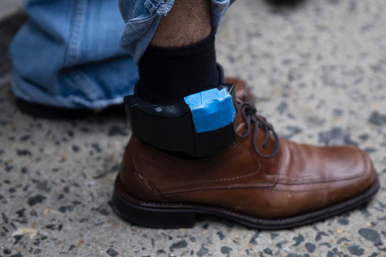 A close up of a monitor attached to a person's ankle.