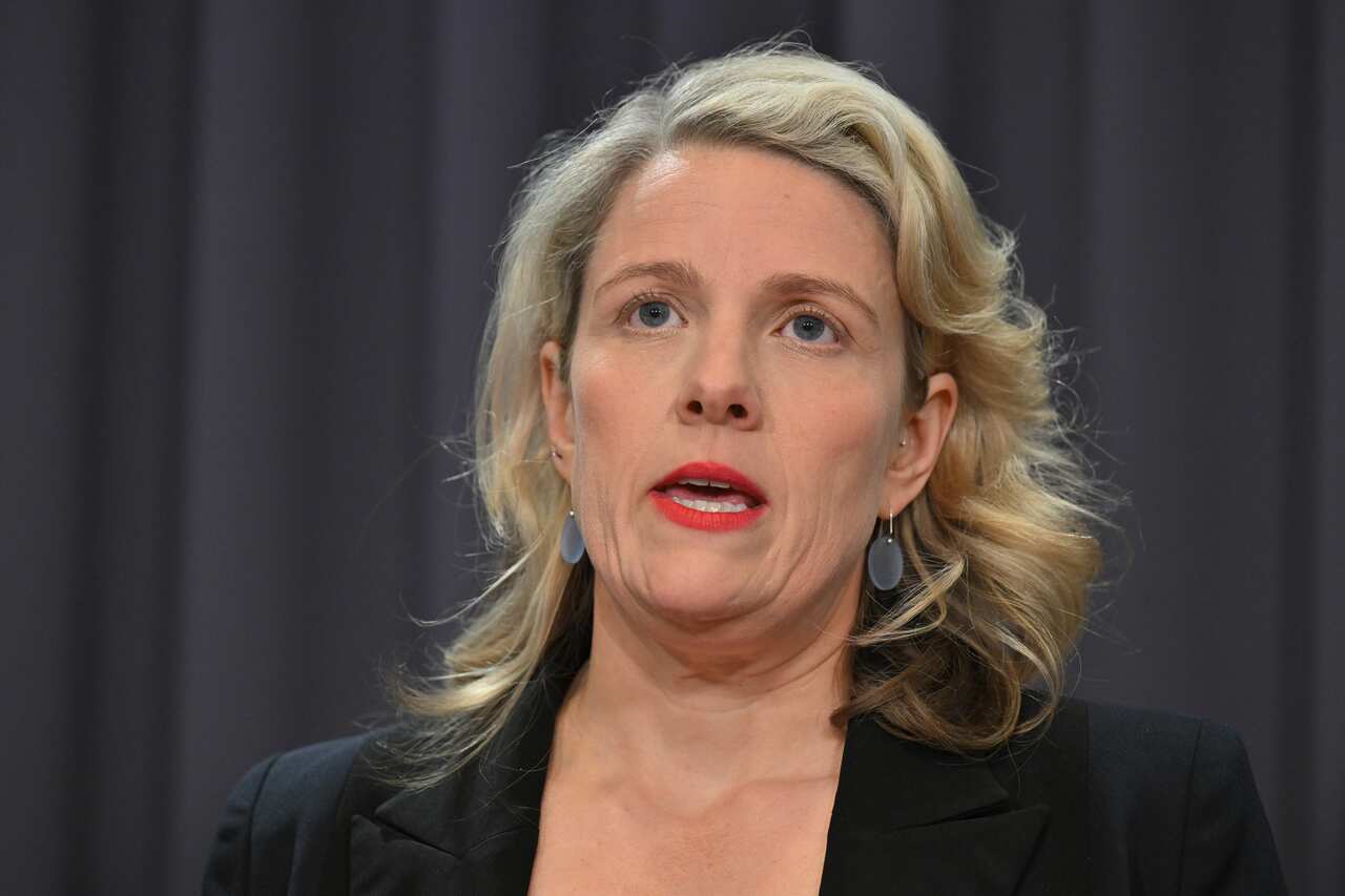 A woman in a black blazer.