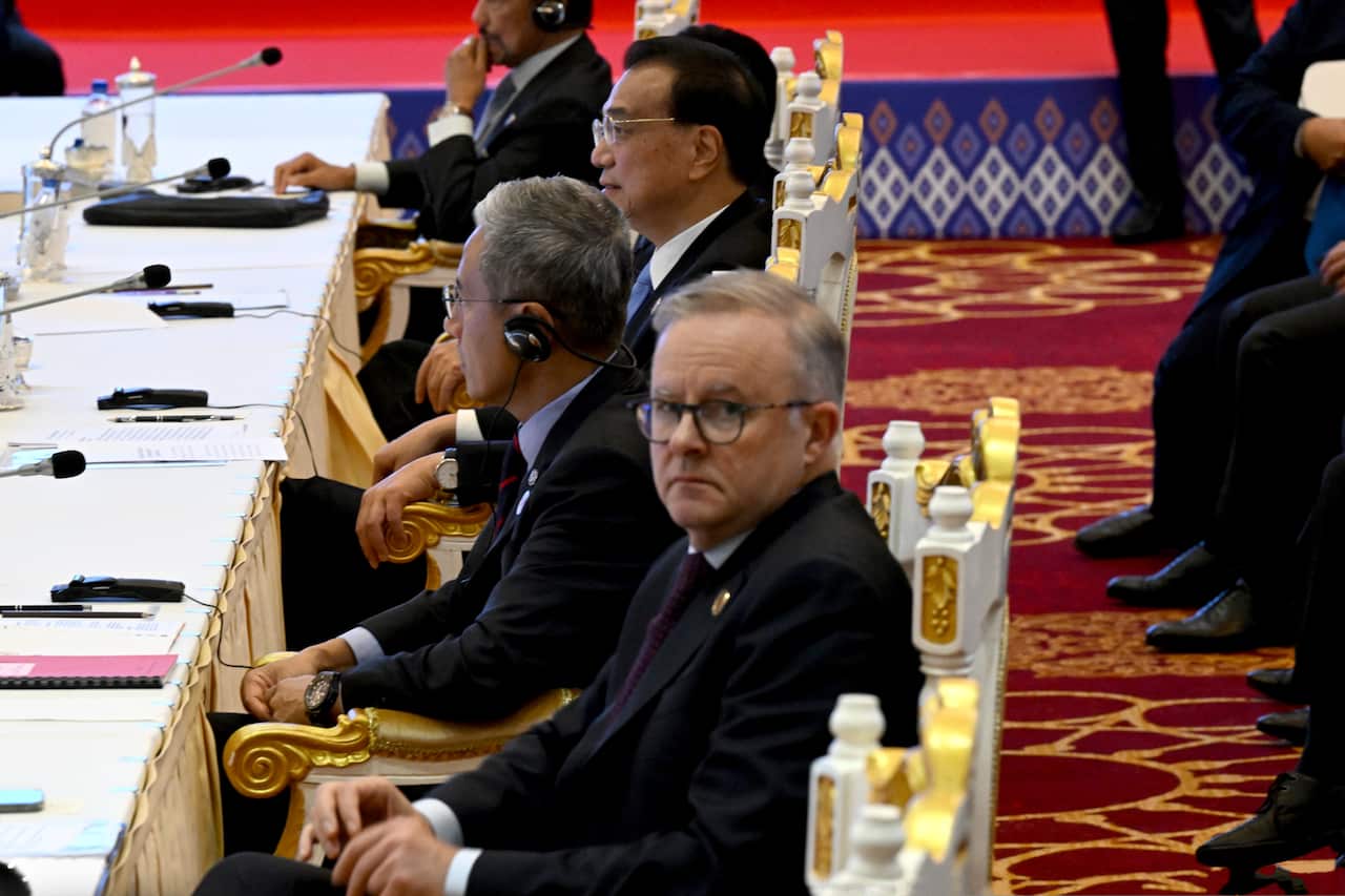 Anthony Albanese sitting in an ornate chair at a large table with other diplomats. 