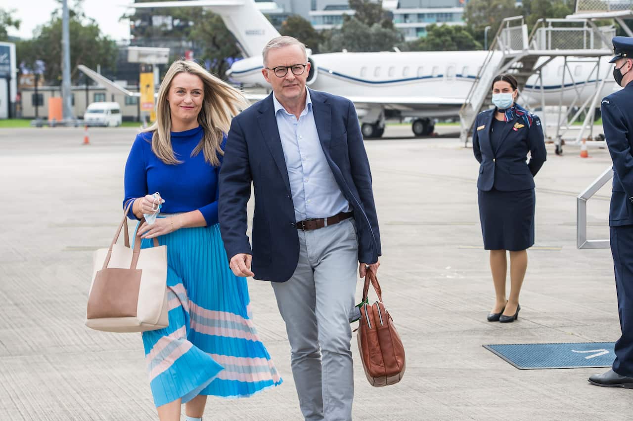 Opposition leader Anthony Albanese and partner Jodie Haydon walking.