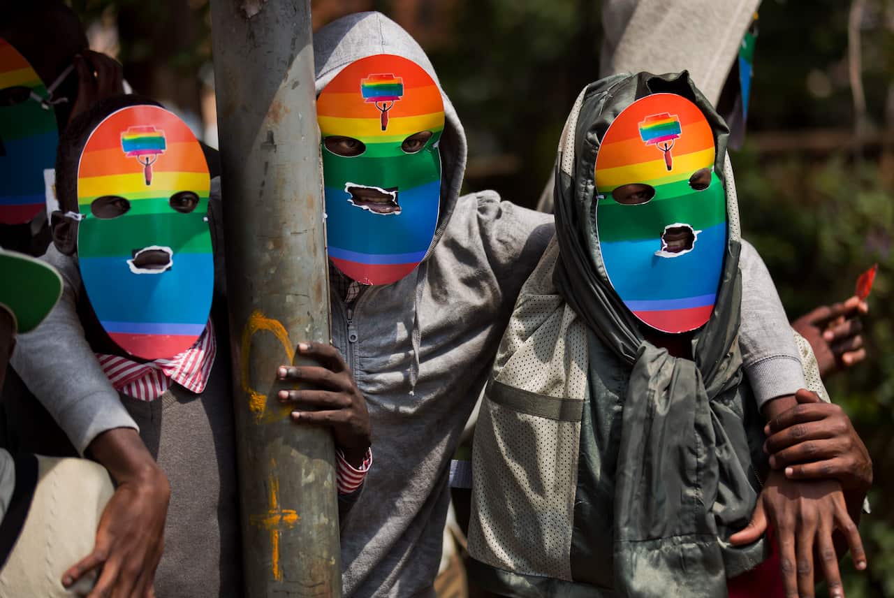 Ugandans wearing rainbow coloured masks