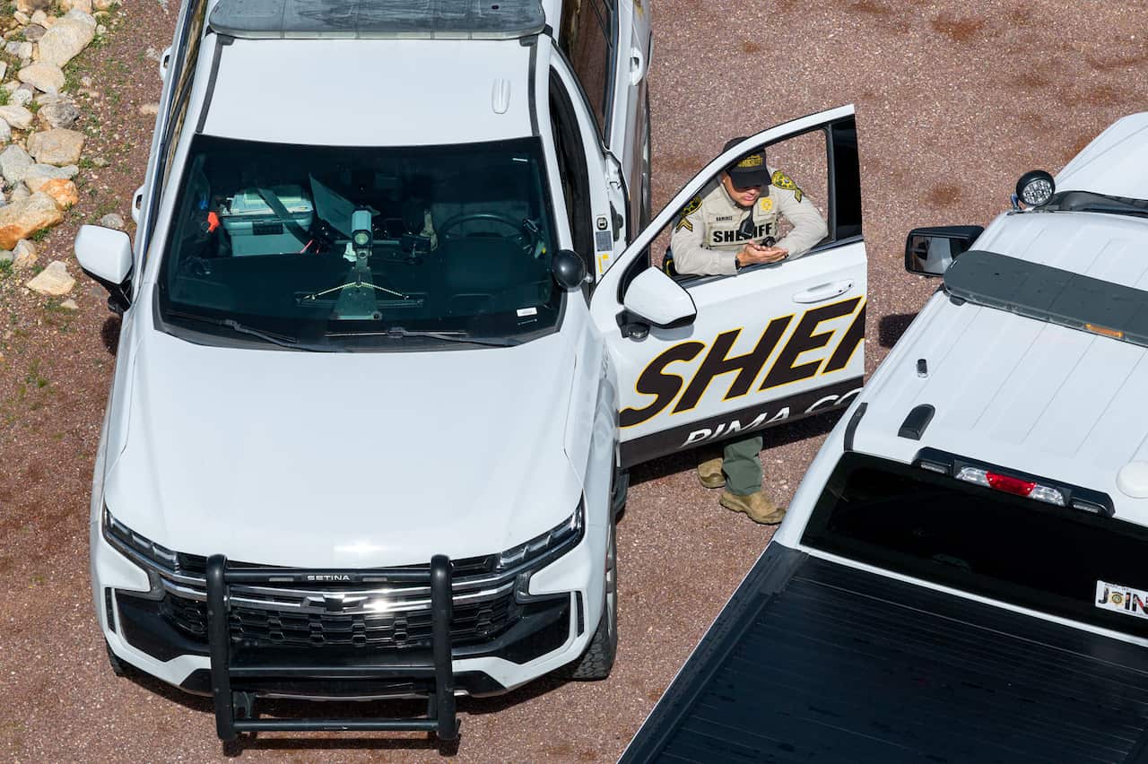 In an aerial view, Pima County Sheriff officers gather on Nancy Guthrie's property.