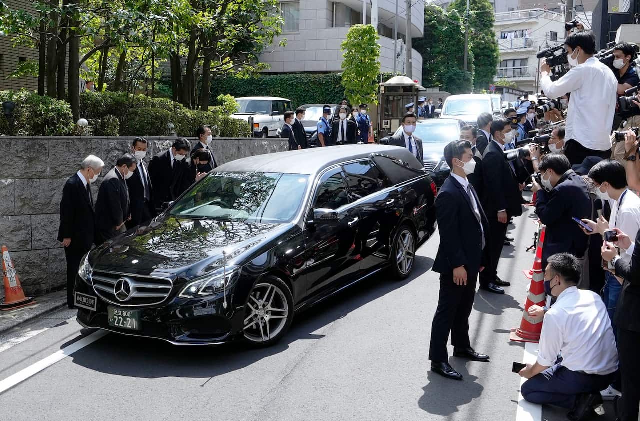 A motorcade carrying the body of Japan's former prime minister Shinzo Abe has arrived at his home in Tokyo.
