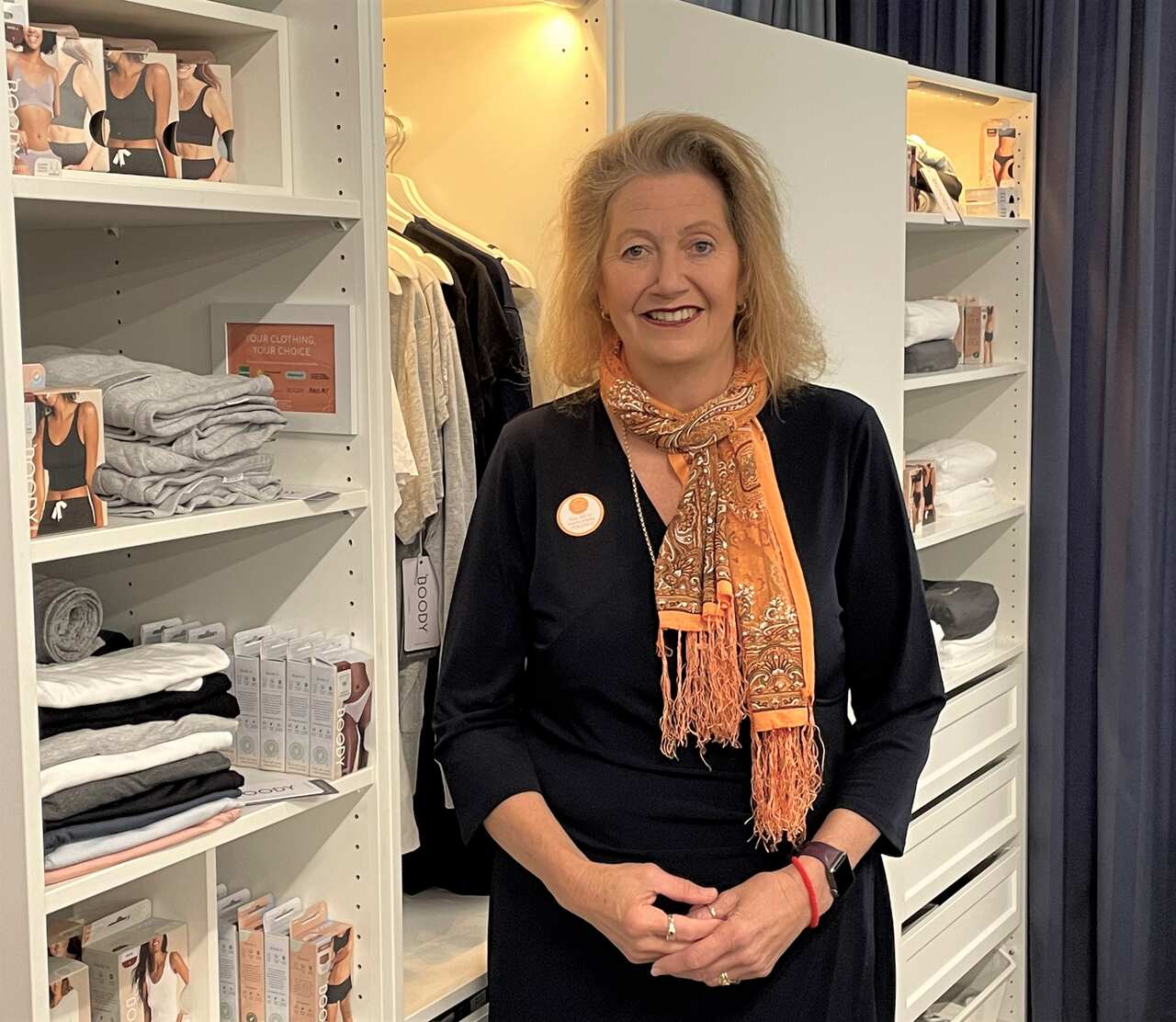 Sallianne Faulkner, Bayside Women's Shelter general manager standing in front of a wardrobe.