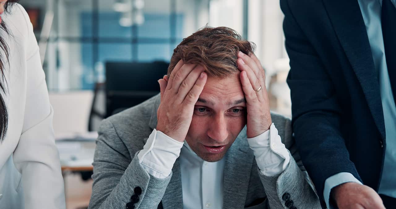Frustrated, businessman or headache with stress for burnout, corporate debt or pressure in office. Tired man, team or colleagues with migraine, anxiety or deadline for company bankruptcy in workplace
