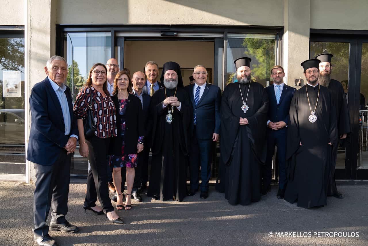 His Eminence Archbishop Makarios, His Grace Bishop Silouan of Sinope, His Grace Bishop Bartholomew of Charioupolis, and the Reverend Archdeacon Athinagoras with members of GOCSA's Administrative Council.png