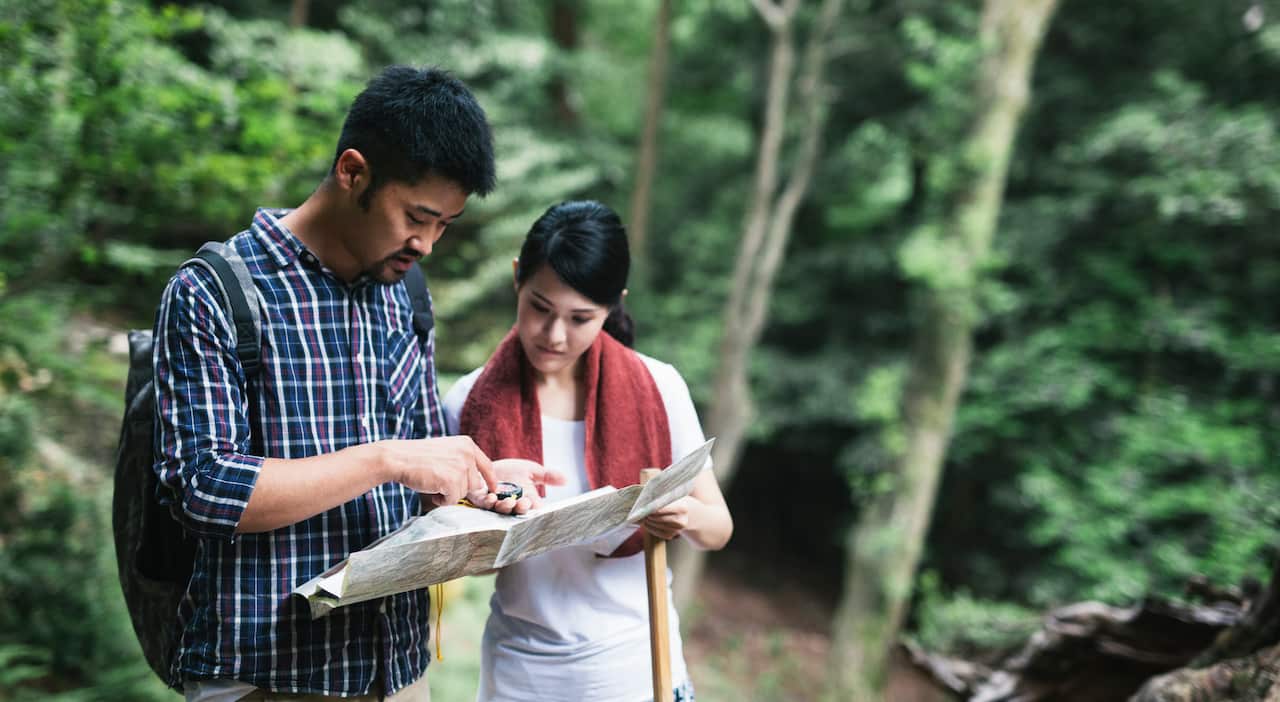 Asian Couple Exploring the Map