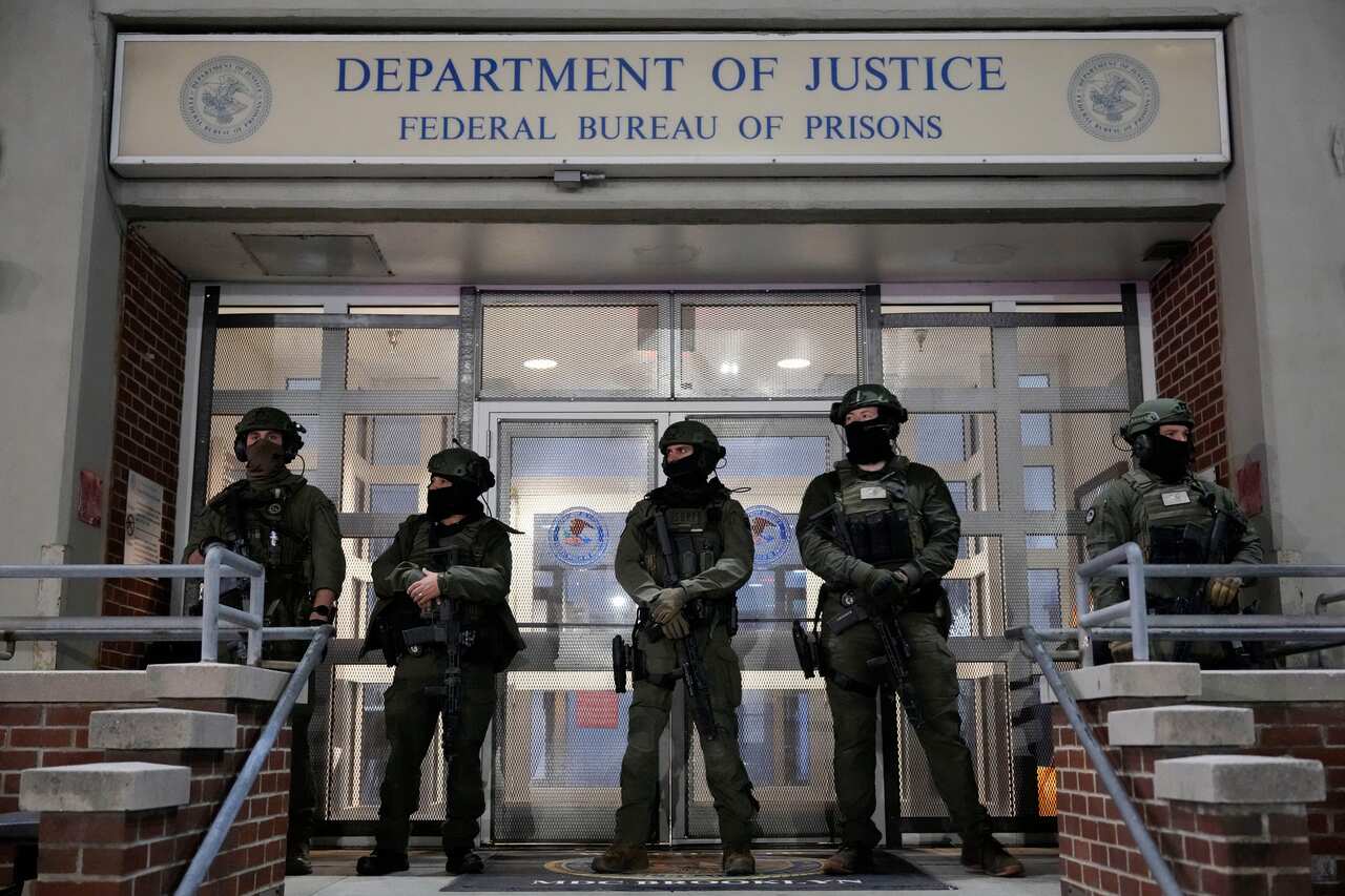 A group of heavily armed military personnel standing outside a building