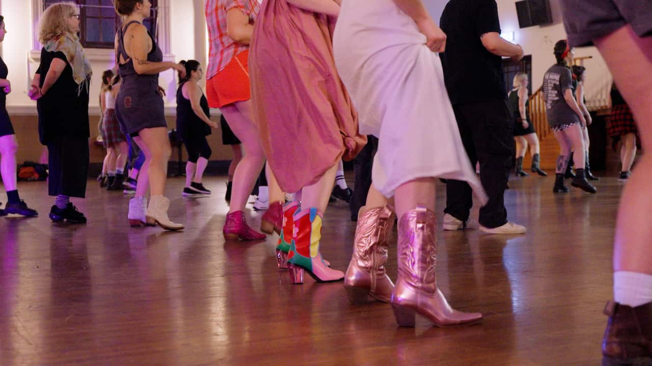 A row of people wearing cowboy boots
