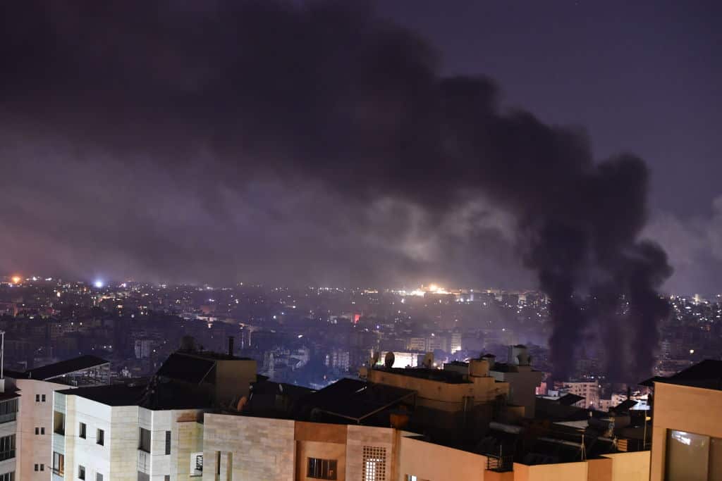 Plumes of smoke rise from the site of an airstrike. 