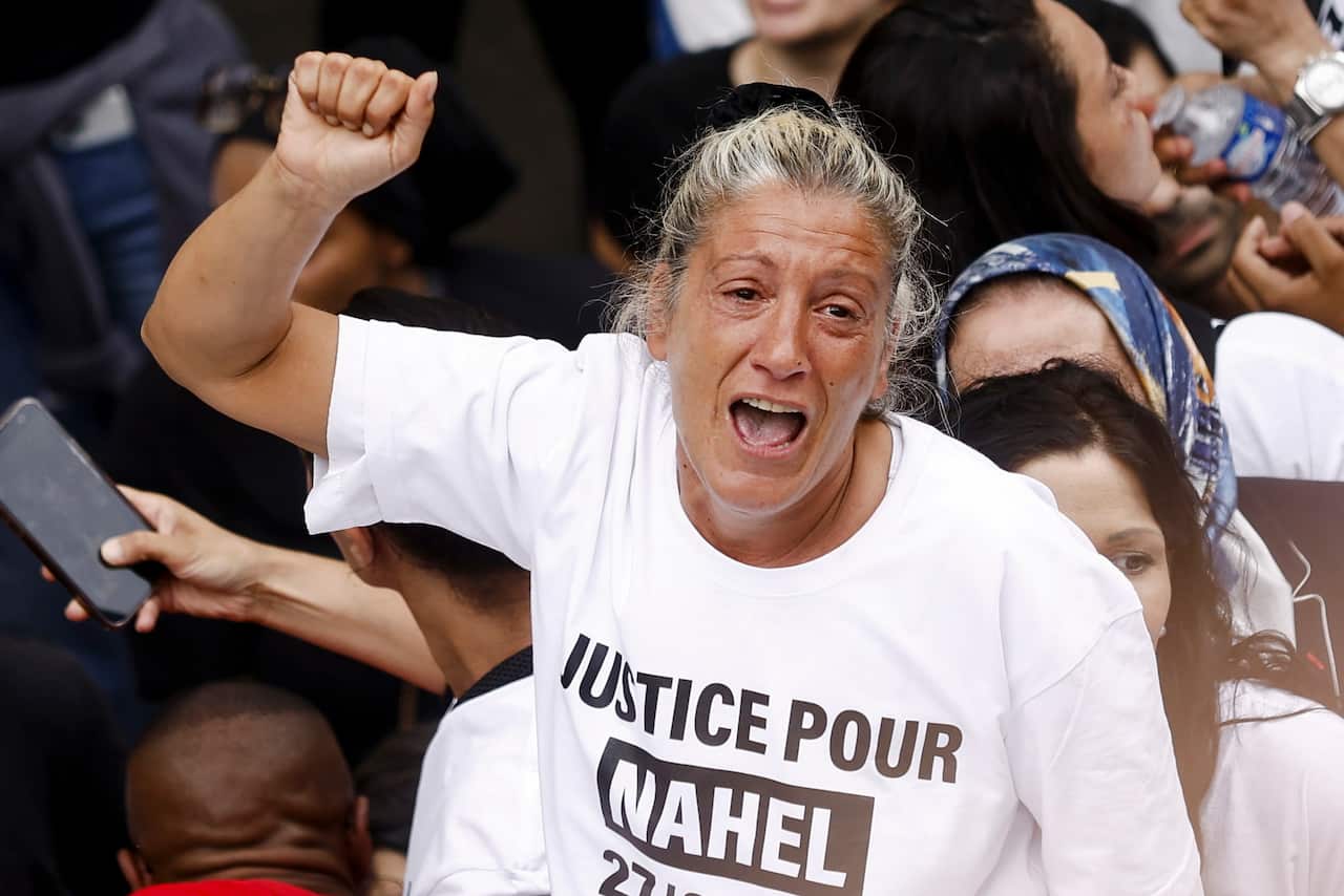 The mother of a 17 year old victim of a police shooting looking overcome with emotion at a protest for her son.