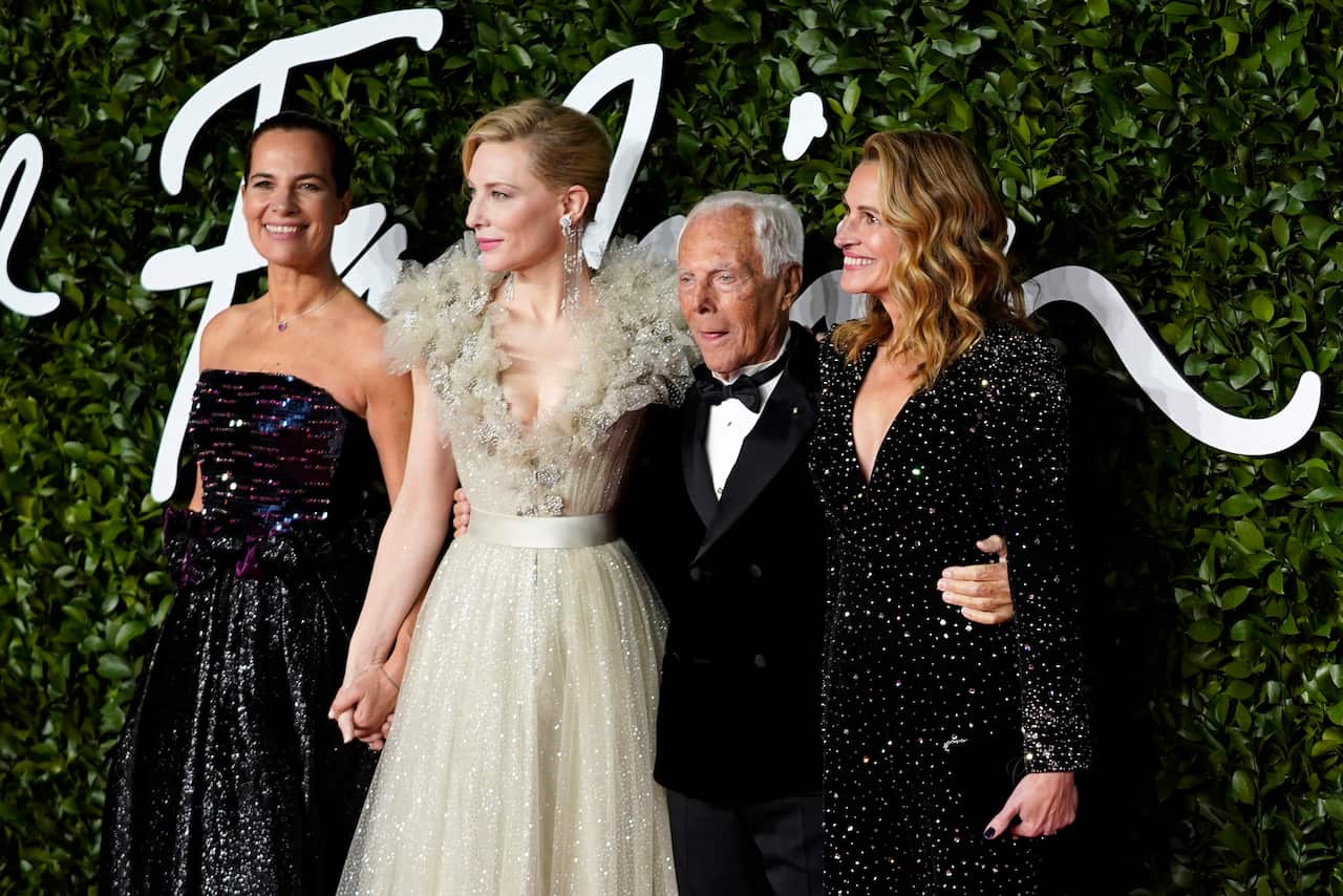 A man is pictured alongside three women at an awards show.