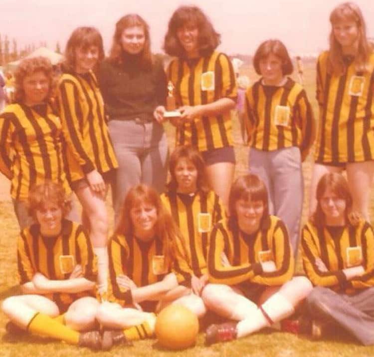 an old photo of a women's football team 