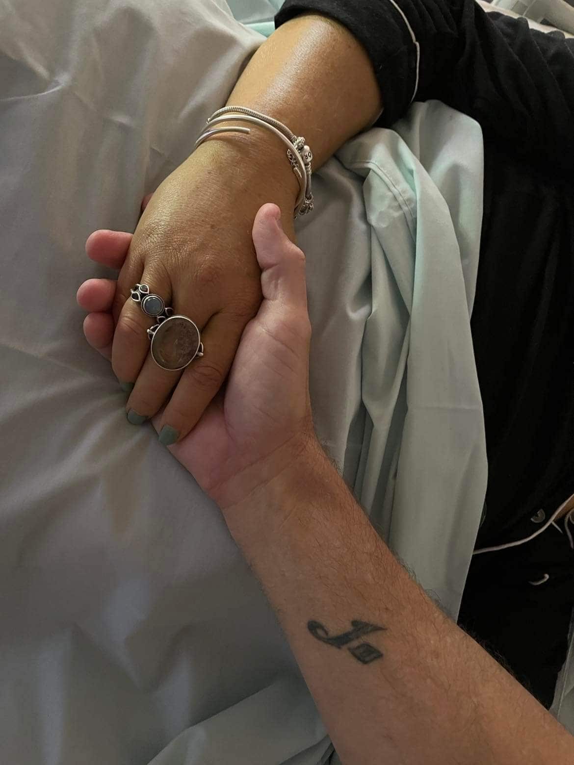 Two hands clasped, in the last photo of Darren and Jo together.