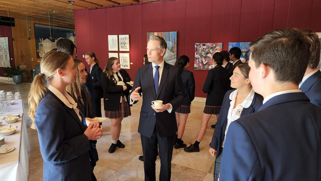Man talking to a group of students