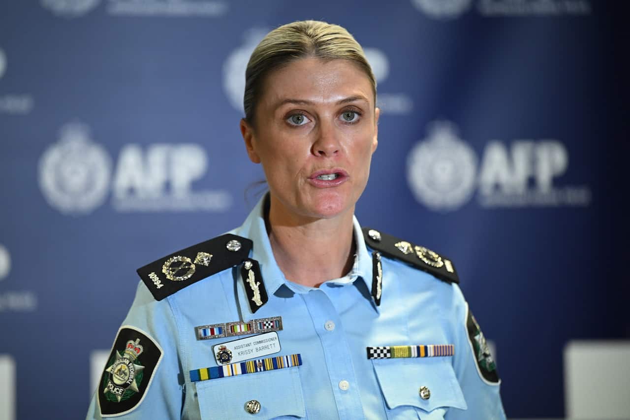 A woman in light blue police uniform shirt speaking