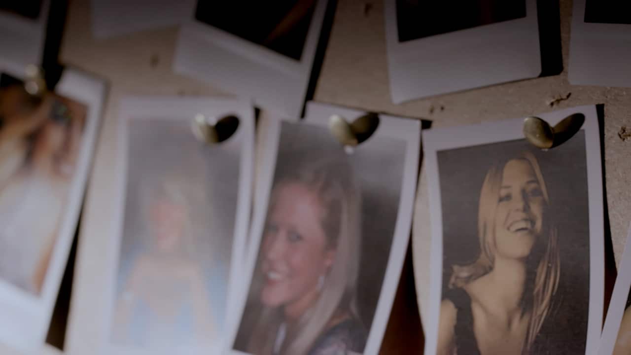 Several Polaroid photos of smiling young women pinned to a board
