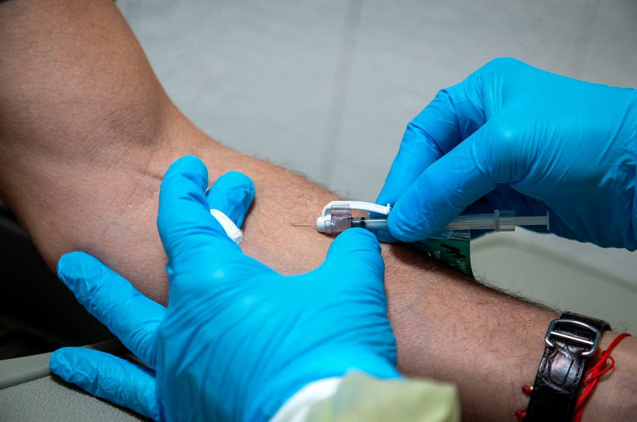 A close-up of a healthcare worker administering a monkeypox vaccine into a person's arm.