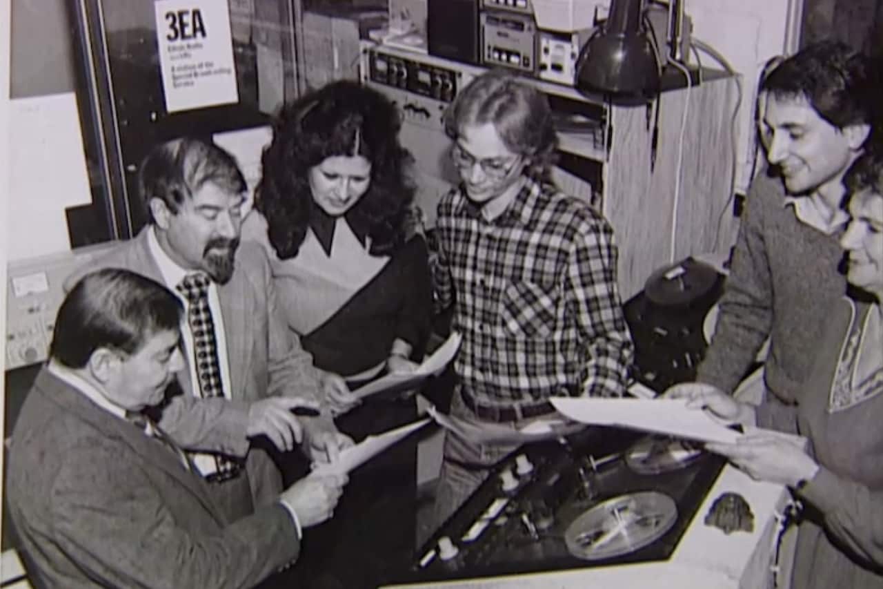 A group of six broadcasters inside the broadcast studio. 