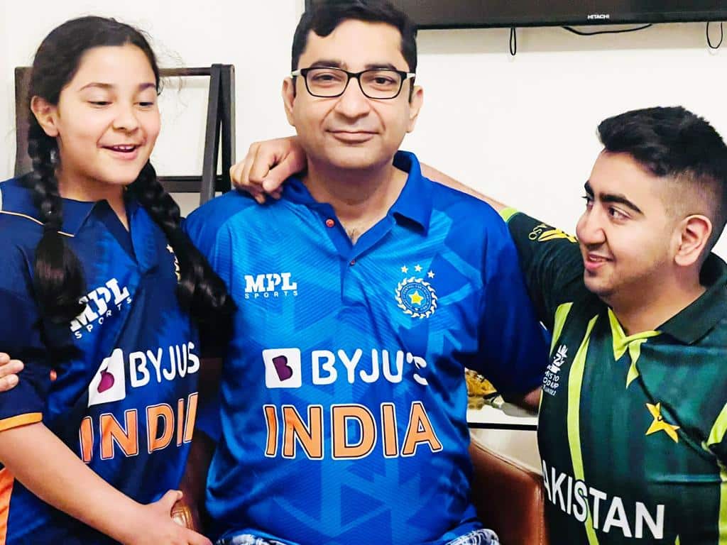 Kids and Dad supporting their respective teams 