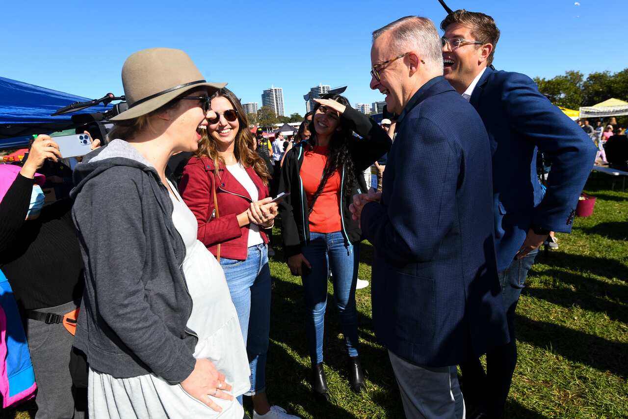 Australian Opposition Leader Anthony Albanese and Labor candidate for the seat of Bennelong Jerome Laxale talk to local residents during a visit to Ryde Wharf Market on Day 28 of the 2022 federal election campaign, in Sydney, Sunday, May 8, 2022. 
