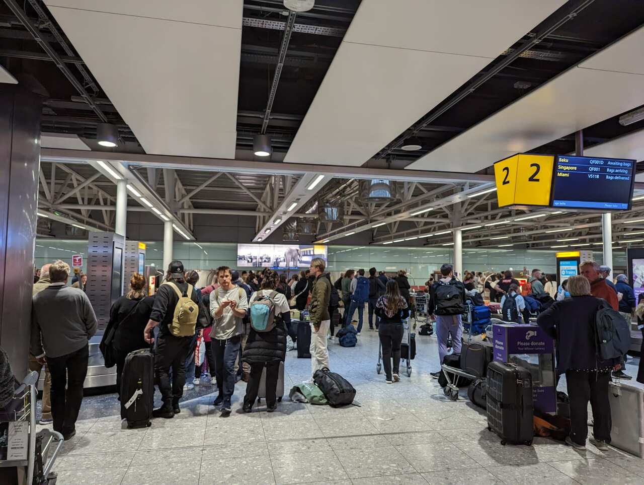 Passengers in an airport with luggage. 