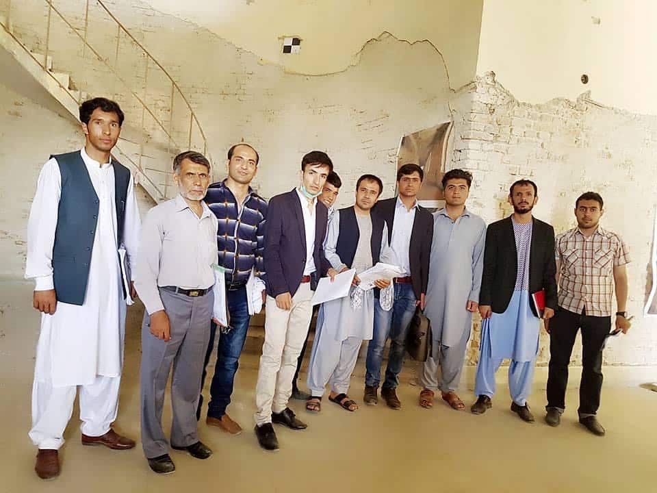 A group of men in Afghanistan standing inside a building