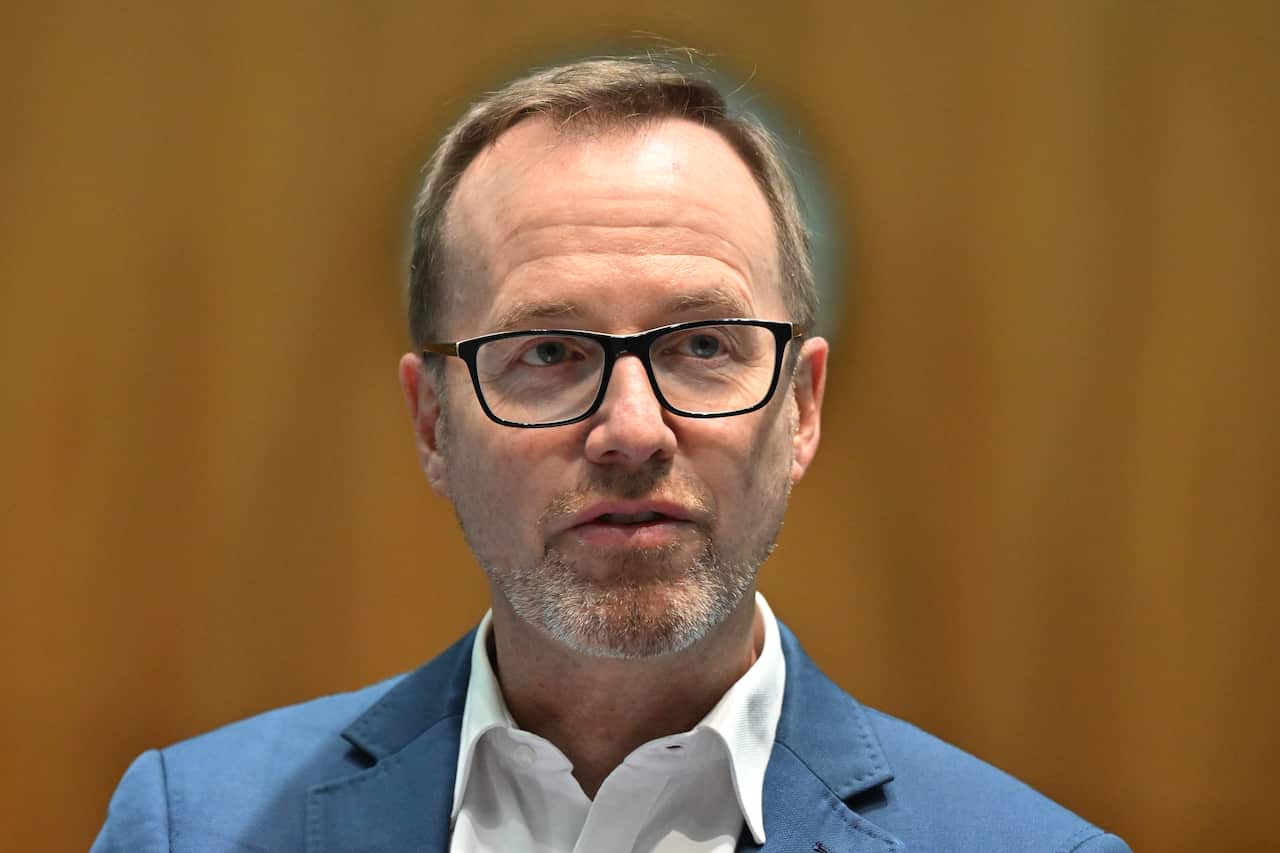 Man in glasses and suit.
