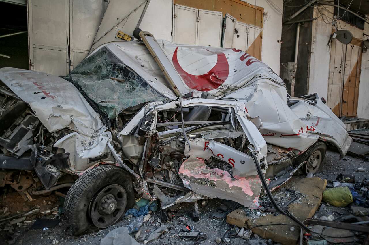 A crushed ambulance with the logo of the red crescent