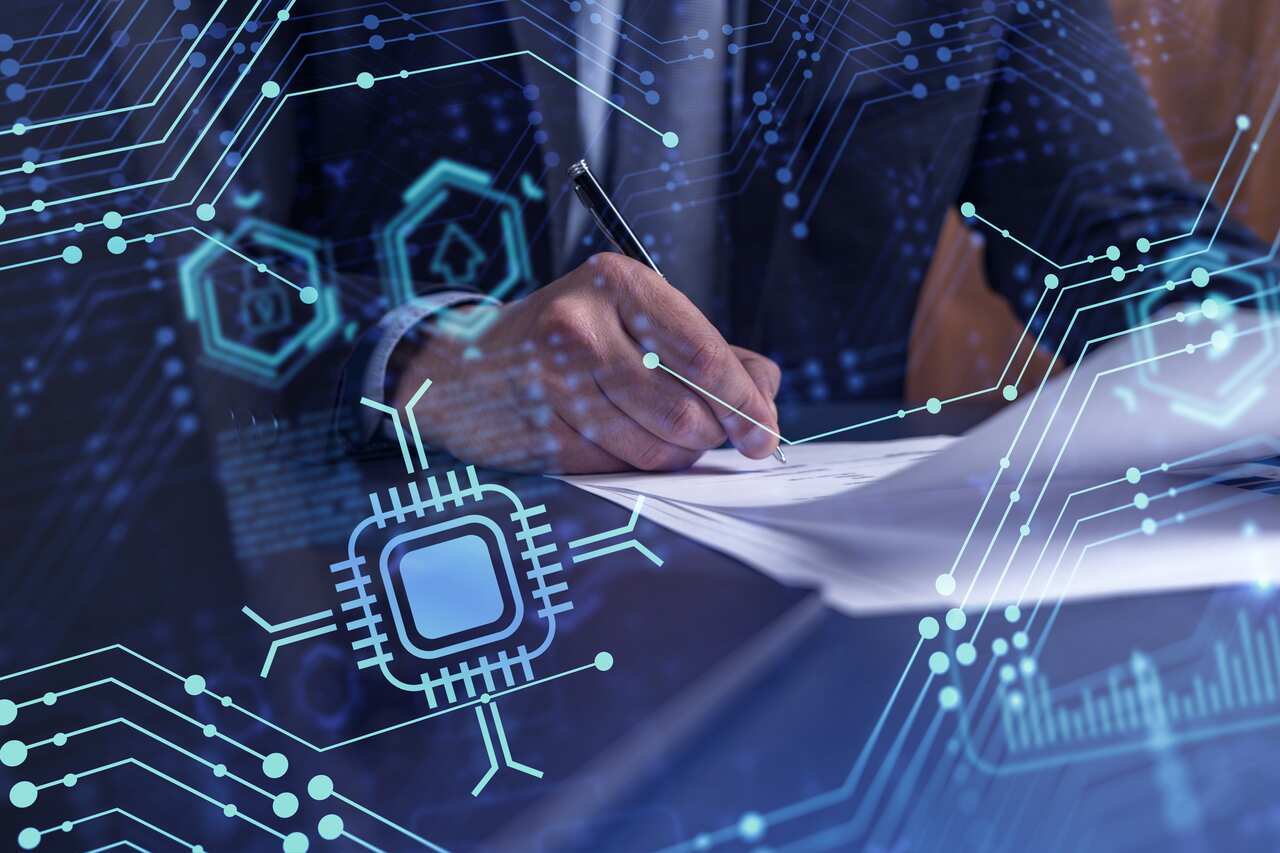 Digital symbols and a hand holding a pen, writing on a piece of paper.