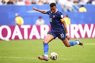A black French football player taking a strike
