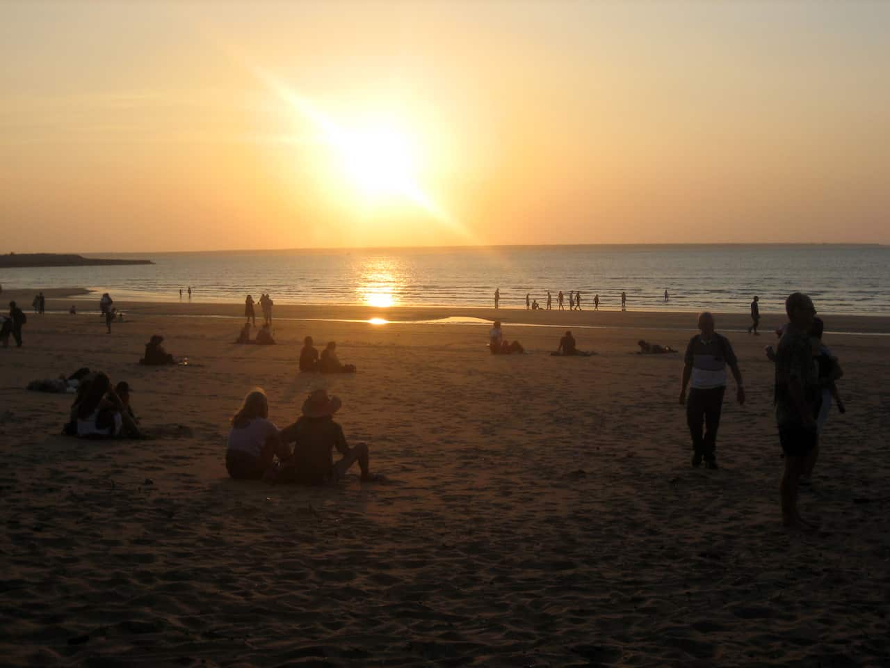 Locals and tourists enjoy the sunset over the Timor Sea from Mindil Beach, Darwin