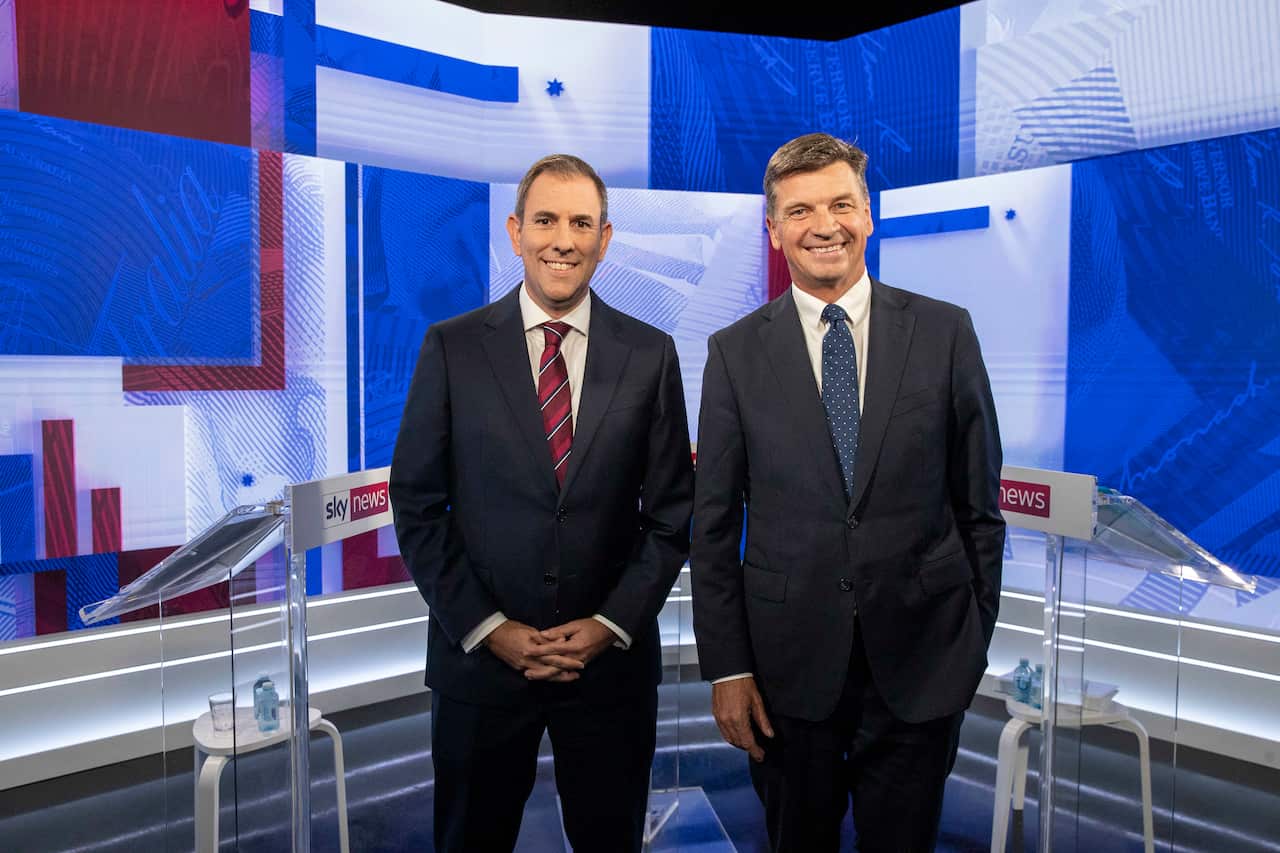 Two men in suits stand in front of Sky News podiums.