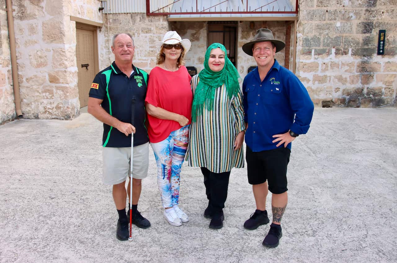 Four visually impaired people standing together